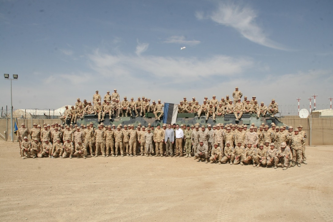 The Estonian Contingent poses for a picture with Estonia’s Minister of Defence, Sven Mikser, center, and other coalition force officials after their farewell ceremony held aboard Camp Bastion, Helmand province, Afghanistan, May 9, 2014. This was the 17th and last Estonian Contingent to deploy to Afghanistan.