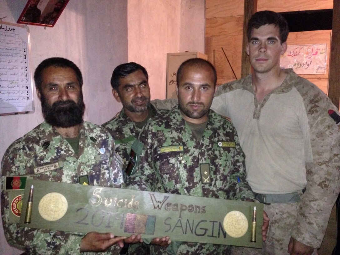 Second Lt. Peter Marks, platoon commander, “Suicide” Charley Company, 1st Battalion, 7th Marine Regiment, and a native of Spokane, Washington, poses for a photo with Afghan National Army Soldiers at Forward Operating Base Sabit Qadam, Afghanistan, May 4, 2014. The company turned over security responsibility of the FOB to the ANA, May 5. The infantrymen of 1st Bn., 7th Marines, were the final Marines to occupy FOB Sabit Qadam and the surrounding area in Sangin District.