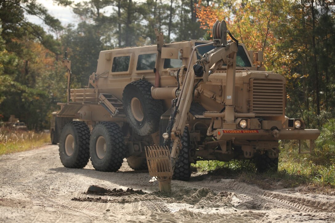 MARINE CORPS BASE CAMP LEJEUNE, N.C. – The Buffalo, a mine-protected vehicle with a robotic arm with a claw and spike attached, uses its claw to search for more buried anti-tank mines during a route clearance course conducted for the Marines of Mobile Assault Company, 2nd Combat Engineer Battalion, 2nd Marine Division, aboard Marine Corps Base Camp Lejeune, Nov. 17. Throughout the day the instructors took note of their dispersion, radio communications, reaction time, how Husky was maneuvering and scanning for IEDs, how the unit set up security and many other details that will affect them when they deploy.