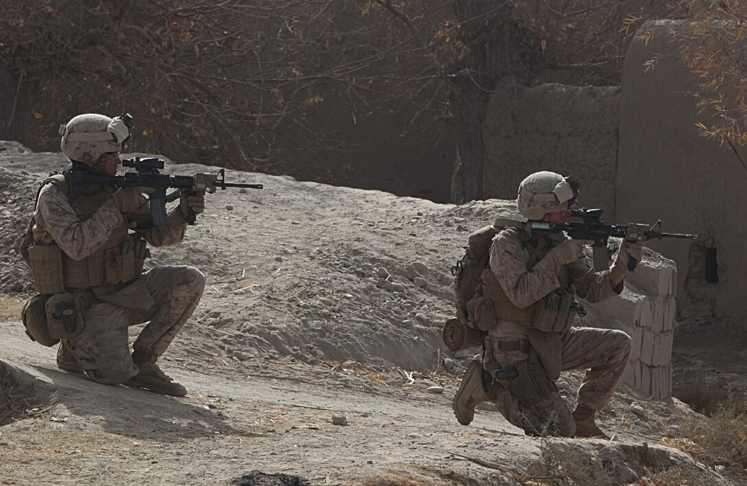 While in Sangin's southern area of operations, Marines scan the area before moving to an objective point, Dec. 23, 2010. The Marines of 2nd Platoon, India Company, 3rd Battalion, 5th Marine Regiment departed Forward Operating Base Jackson on an operation to secure a new patrol base in the area. Although the Marines were met with enemy fire, they quickly maneuvered, killed the enemy and seized their objective area.