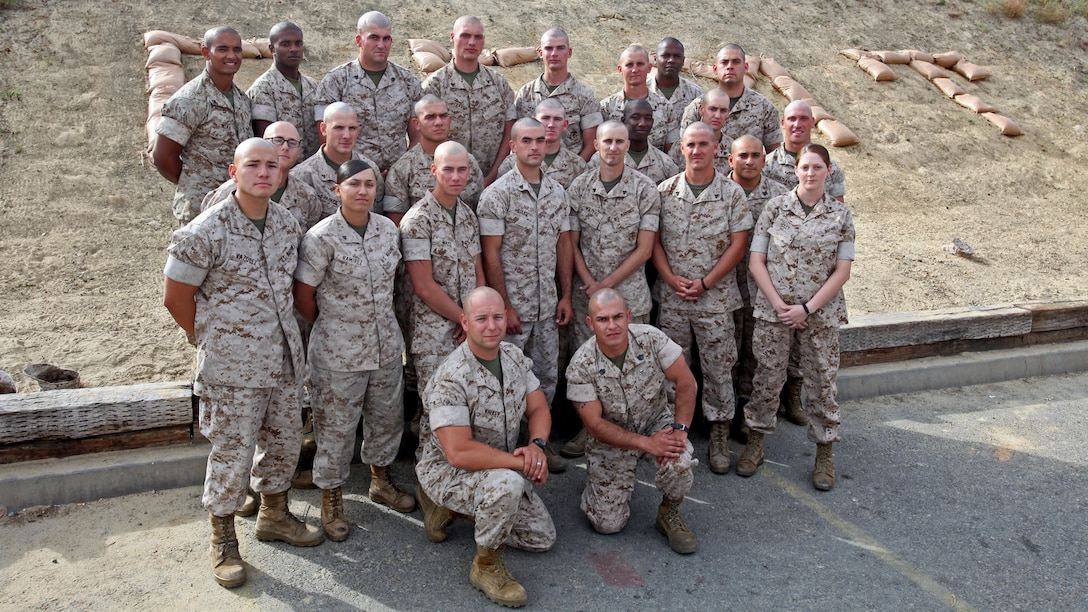Marines with 2nd Platoon, General Support Motor Transport Company, Combat Logistics Regiment 1,1st Marine Logistics Group, pose for a platoon photo aboard Camp Pendleton, Calif., May 5, 2014. Nineteen Marines with 2nd Platoon, General Support Motor Transport Company, Combat Logistics Regiment 1, 1st Marine Logistics Group, shaved their heads in support their platoon sergeant’s 16-year old cousin, Diego Romero, aboard Camp Pendleton, Calif. Staff Sgt. Juan Garcia, platoon sergeant, 2nd Plt., has a father-son relationship with Romero. He sent out a mass text letting his Marines know that Romero has leukemia, and that he shaved his head to support his cousin. His Marines decided they would shave their heads as well, showing that the Corps is a family, and showing Garcia that he has their support.