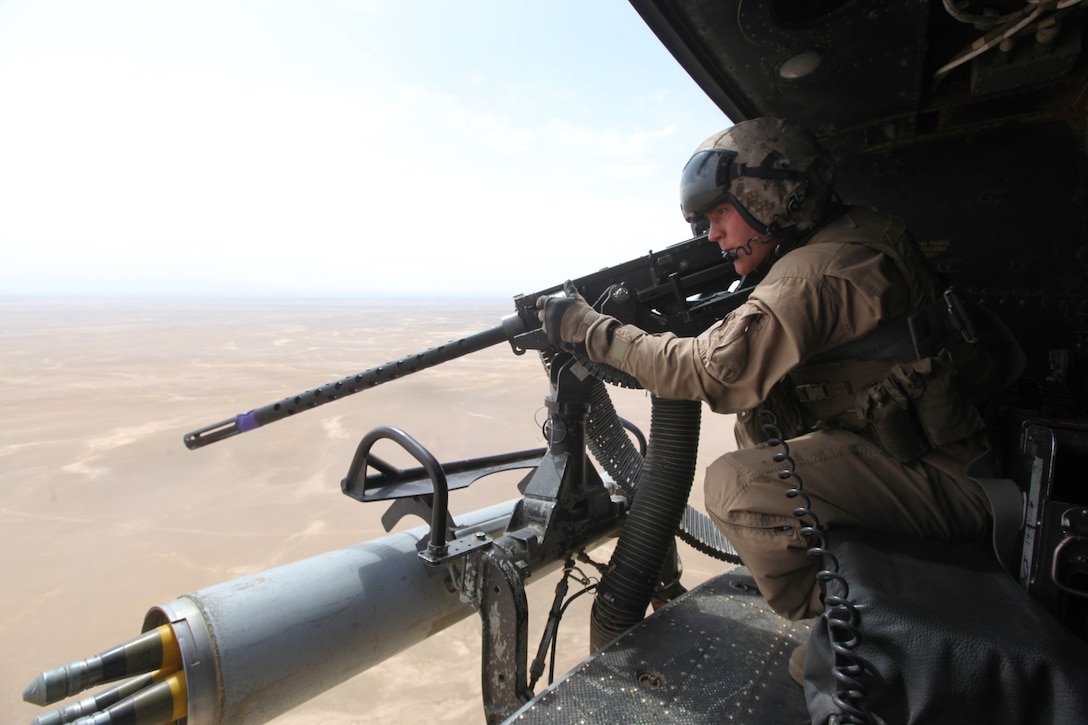 Corporal Andrew Harris, a UH-1Y Huey crew chief with Marine Light Attack Helicopter Squadron 369, and a Highland, Illinois, native, performs a weapons check before an aerial assault support mission for ground convoys in Helmand province, Afghanistan, May 3, 2014. Before the last Marines and sailors of Forward Operating Bases Nolay and Sabit Qadam convoyed out of northern Helmand to return to Camp Leatherneck for the final time, the “Gunfighters” of HMLA-369 and “Heavyweights” of Marine Heavy Helicopter Squadron 466 provided overwatch for returning vehicle convoys as well as retrograde support. (U.S. Marine Corps Photo By: Sgt. Frances Johnson/Released)