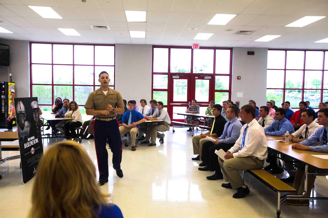 RARITAN, N.J.—Capt. Zachary Smith, executive officer of Recruiting Station New Jersey, speaks to the 2014 Basilone Bowl football players and their families during their first meeting May 12 at Bridgewater Raritan High School. The Basilone Bowl is an event created by the Marine Corps to honor Gunnery Sgt. John Basilone, as well as pass on the Marine Corps leadership traits to the young leaders of tomorrow. (U.S. Marine Corps photo by Lance Cpl. Brandon Thomas)