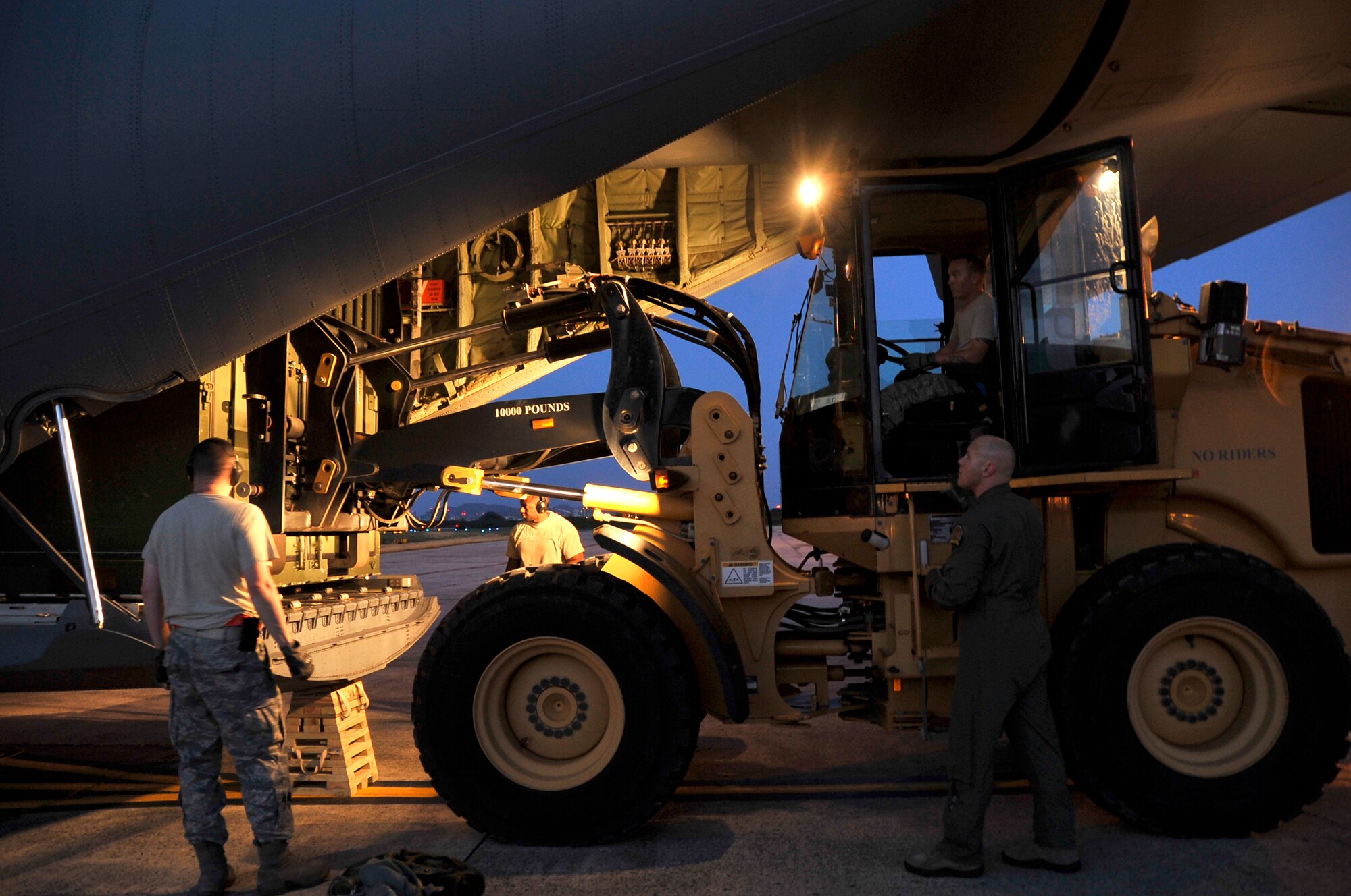 Master Sgt. Boyd Huff and Tech. Sgt. Adrian Barlow, 41st Aerial Port Squadron air transportation specialists, (pictured on left), Staff Sgt. Shaun Rhine, 345th Airlift Squadron air transportation specialists, (forklift driver), and Master Sgt. Ed Scherzer, (pictured on right), 53rd Weather Reconnaissance Squadron loadmaster, unload equipment from a WC-130J aircraft at the Henry E. Rohlsen Airport in St. Croix, U.S. Virgin Islands May 5-11, 2014.  An evening arrival of the aircraft was unloaded of supplies and aircraft parts needed to provide maintenance on the aircrafts during the upcoming hurricane season.  (U.S. Air Force photo/Master Sgt. Jessica L. Kendziorek)