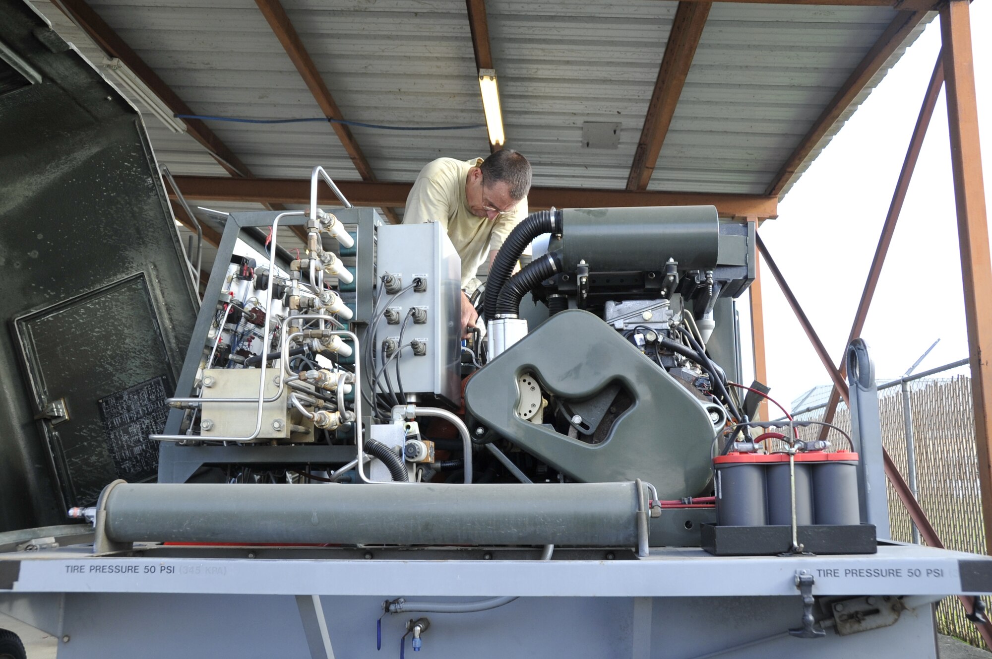 Master Sgt. Harold Martin, 403rd Maintenance Squadron maintenance shop supervisor, performs routine maintenance on a nitrogen cart at the Henry E. Rohlsen Airport in St. Croix, U.S. Virgin Islands May 5-11, 2014.  The nitrogen cart is primarily used to put air in the tires on the WC130-J aircraft during the hurricane season.  (U.S. Air Force photo/Master Sgt. Jessica L. Kendziorek)