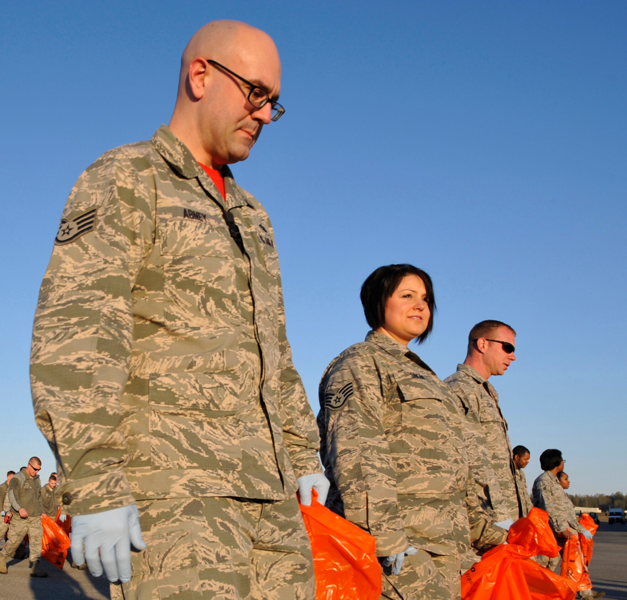 Airmen look for trash during the annual foreign object damage walk on the flight line on Joint Base Elmendorf-Richardson, Alaska, May 9, 2014. During the FOD walks, volunteers pick up objects lying on the ground that can get pulled in by the air intake suction of jet engines and cause damage to the engine. More than 1,800 volunteers participated in this year’s FOD walk. (U.S. Air Force photo/Airman 1st Class Tammie Ramsouer)