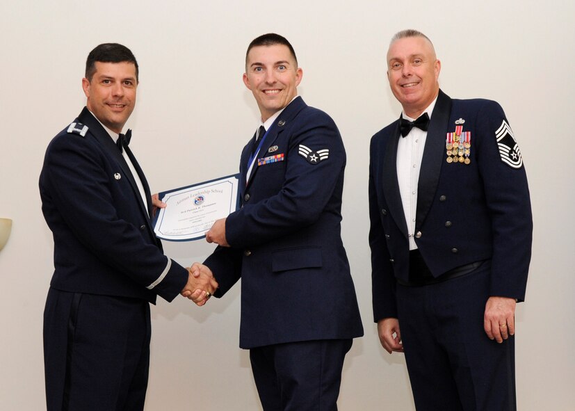 Senior Airman Patrick Thompson, 2nd Aircraft Maintenance Squadron, receives an Airman Leadership School graduation certificate from Col. Andrew Gebara, 2nd Bomb Wing commander, on Barksdale Air Force Base, La., May 8, 2014. (U.S. Air Force photo/Senior Airman Joseph A. Pagán Jr.)