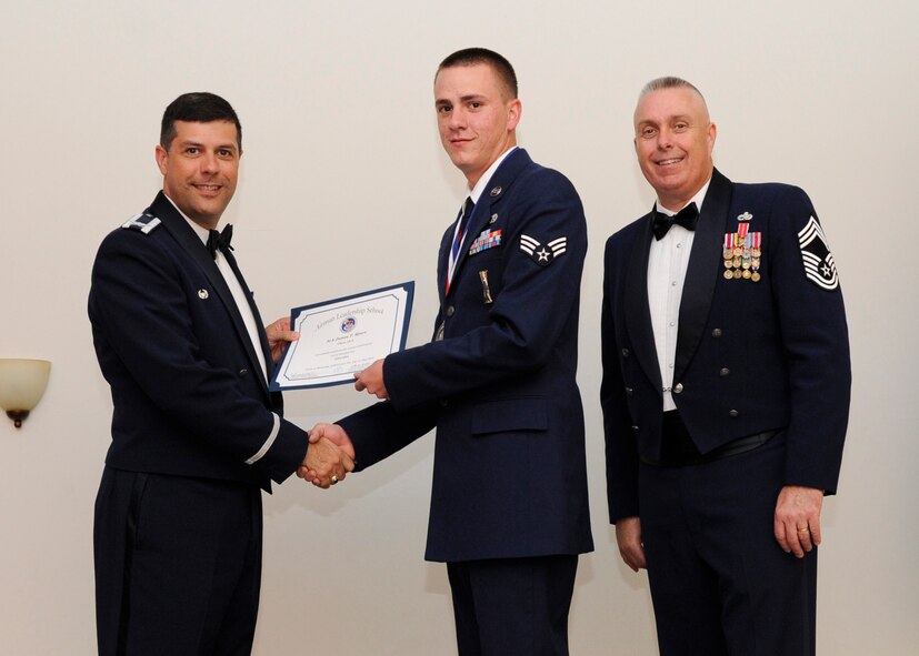 Senior Airman James Myers, 2nd Aircraft Maintenance Squadron, receives an Airman Leadership School graduation certificate from Col. Andrew Gebara, 2nd Bomb Wing commander, on Barksdale Air Force Base, La., May 8, 2014. (U.S. Air Force photo/Senior Airman Joseph A. Pagán Jr.)