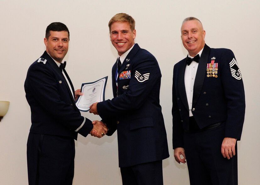 Staff Sgt. Eric Minnix, 20th Air Support Squadron Detachment 1, Fort Polk, La., receives an Airman Leadership School graduation certificate from Col. Andrew Gebara, 2nd Bomb Wing commander, on Barksdale Air Force Base, La., May 8, 2014. (U.S. Air Force photo/Senior Airman Joseph A. Pagán Jr.)