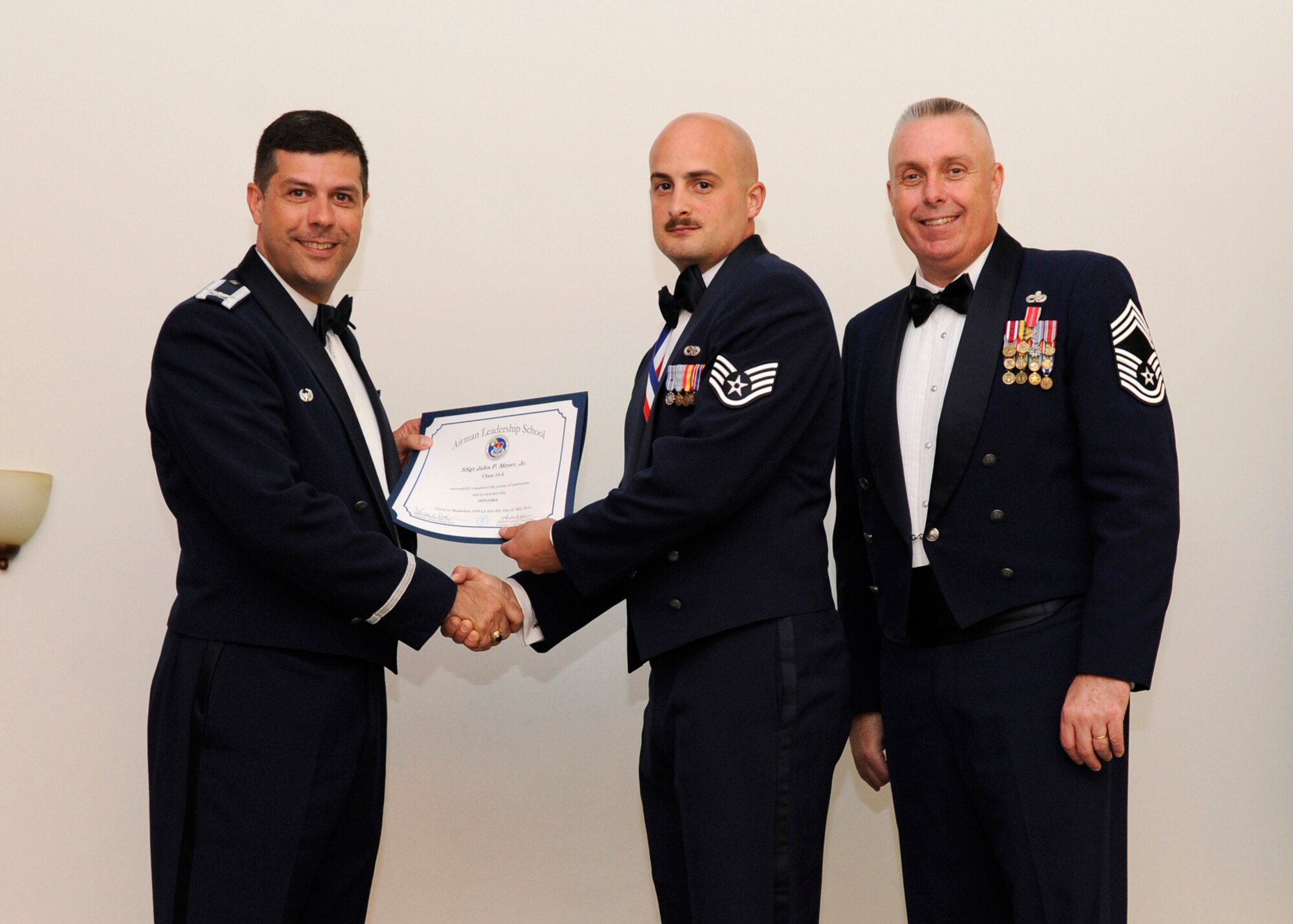 Staff Sgt. John Meyer Jr., 2nd Aircraft Maintenance Squadron, receives an Airman Leadership School graduation certificate from Col. Andrew Gebara, 2nd Bomb Wing commander, on Barksdale Air Force Base, La., May 8, 2014. (U.S. Air Force photo/Senior Airman Joseph A. Pagán Jr.)