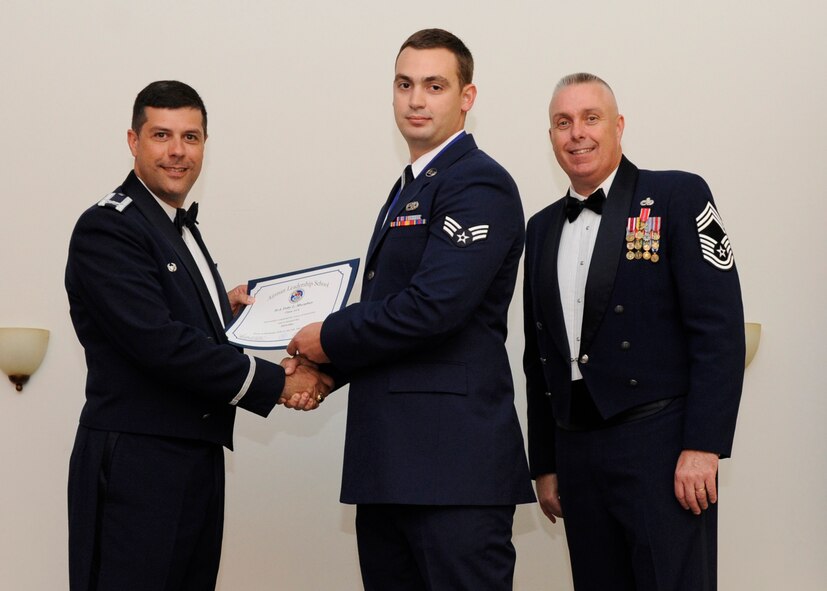 Senior Airman Toby Murphey, 2nd Aircraft Maintenance Squadron, receives an Airman Leadership School graduation certificate from Col. Andrew Gebara, 2nd Bomb Wing commander, on Barksdale Air Force Base, La., May 8, 2014. (U.S. Air Force photo/Senior Airman Joseph A. Pagán Jr.)