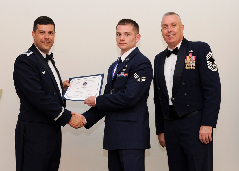 Senior Airman Anthony Kirk Jr., 2nd Logistics Readiness Squadron, receives an Airman Leadership School graduation certificate from Col. Andrew Gebara, 2nd Bomb Wing commander, on Barksdale Air Force Base, La., May 8, 2014. (U.S. Air Force photo/Senior Airman Joseph A. Pagán Jr.)