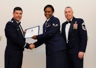 Senior Airman Lasheda House, 434th Maintenance Group, Grissom Air Reserve Base, Ind., receives an Airman Leadership School graduation certificate from Col. Andrew Gebara, 2nd Bomb Wing commander, on Barksdale Air Force Base, La., May 8, 2014. (U.S. Air Force photo/Senior Airman Joseph A. Pagán Jr.)