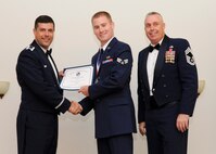 Senior Airman Austin Groupp, 2nd Maintenance Squadron, receives an Airman Leadership School graduation certificate from Col. Andrew Gebara, 2nd Bomb Wing commander, on Barksdale Air Force Base, La., May 8, 2014. (U.S. Air Force photo/Senior Airman Joseph A. Pagán Jr.)