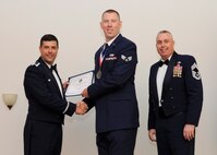 Senior Airman Benjamin Follansbee, 2nd Munitions Squadron, receives an Airman Leadership School graduation certificate from Col. Andrew Gebara, 2nd Bomb Wing commander, on Barksdale Air Force Base, La., May 8, 2014. (U.S. Air Force photo/Senior Airman Joseph A. Pagán Jr.)