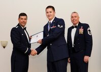 Senior Airman Benjamin Elliott, 2nd Aircraft Maintenance Squadron, receives an Airman Leadership School graduation certificate from Col. Andrew Gebara, 2nd Bomb Wing commander, on Barksdale Air Force Base, La., May 8, 2014. (U.S. Air Force photo/Senior Airman Joseph A. Pagán Jr.)