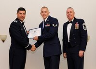 Senior Airman Michael Dormeier, 2nd Communications Squadron, receives an Airman Leadership School graduation certificate from Col. Andrew Gebara, 2nd Bomb Wing commander, on Barksdale Air Force Base, La., May 8, 2014. (U.S. Air Force photo/Senior Airman Joseph A. Pagán Jr.)