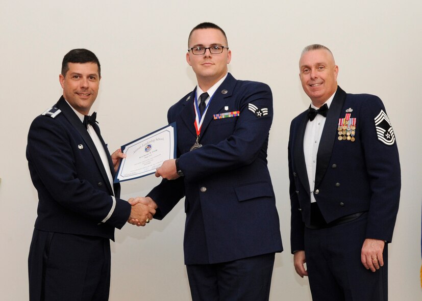 Senior Airman Aaron Craig, 2nd Medical Operations Squadron, receives an Airman Leadership School graduation certificate from Col. Andrew Gebara, 2nd Bomb Wing commander, on Barksdale Air Force Base, La., May 8, 2014. (U.S. Air Force photo/Senior Airman Joseph A. Pagán Jr.)