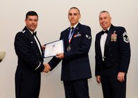 Senior Airman Adam Casillas, 2nd Maintenance Squadron, receives an Airman Leadership School graduation certificate from Col. Andrew Gebara, 2nd Bomb Wing commander, on Barksdale Air Force Base, La., May 8, 2014. (U.S. Air Force photo/Senior Airman Joseph A. Pagán Jr.)