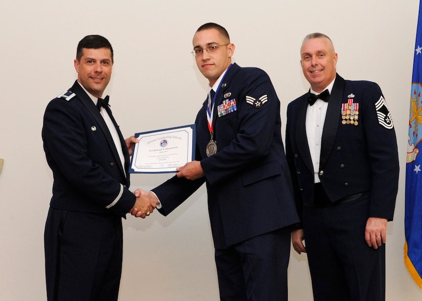 Senior Airman Michael Bustamante, 2nd Civil Engineer Squadron, receives an Airman Leadership School graduation certificate from Col. Andrew Gebara, 2nd Bomb Wing commander, on Barksdale Air Force Base, La., May 8, 2014. (U.S. Air Force photo/Senior Airman Joseph A. Pagán Jr.)