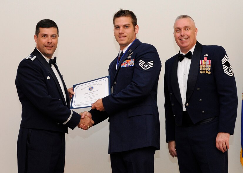 Staff Sgt. Geoffrey Braid, 20th Air Support Squadron Detachment 1, Fort Polk, La., receives an Airman Leadership School graduation certificate from Col. Andrew Gebara, 2nd Bomb Wing commander, on Barksdale Air Force Base, La., May 8, 2014. (U.S. Air Force photo/Senior Airman Joseph A. Pagán Jr.)
