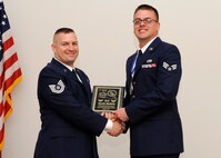 Senior Airman Jacob Mehlin, 2nd Operations Support Squadron, receives the Distinguished Graduate Award from Tech. Sgt. Troy Hartman, 2nd Maintenance Squadron, on behalf of the Air Force Sergeants Association during the Airman Leadership School class 14-4 graduation on Barksdale Air Force Base, La., May 8, 2014. (U.S. Air Force photo/Senior Airman Joseph A. Pagán Jr.)