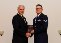 Senior Airman Jacob Mehlin, 2nd Operations Support Squadron, receives the Academic Award from Bill Mesloh, Embry Riddle Aeronautical University, during the Airman Leadership School class 14-4 graduation on Barksdale Air Force Base, La., May 8, 2014. (U.S. Air Force photo/Senior Airman Joseph A. Pagán Jr.)