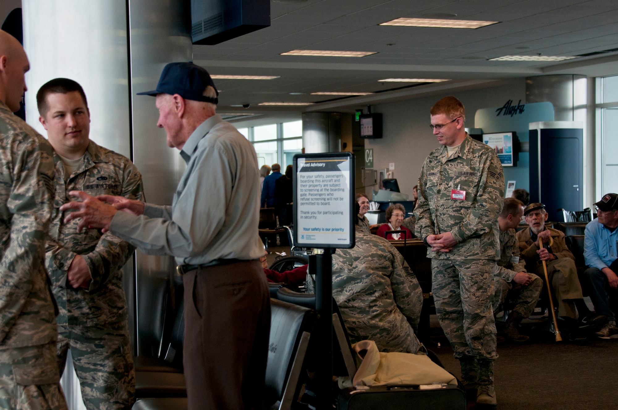 JOINT BASE ELMENDORF-RICHARDSON, Alaska -- About 45 Guardsmen of the Alaska Air National Guard's 176th Wing assisted and interacted with almost 50  World War II veterans at Ted Stevens International Airport on May 6, 2014. The Alaska veterans were on their way to visit their monuments in Washingtion, D.C., for the first time thanks to organizations such as the Golden Heart and Last Frontier Honor Flight programs, and Alaska Airlines, which provided the veterans' tickets. U.S. Air National Guard photo by Staff Sgt N. Alicia Halla/ Released