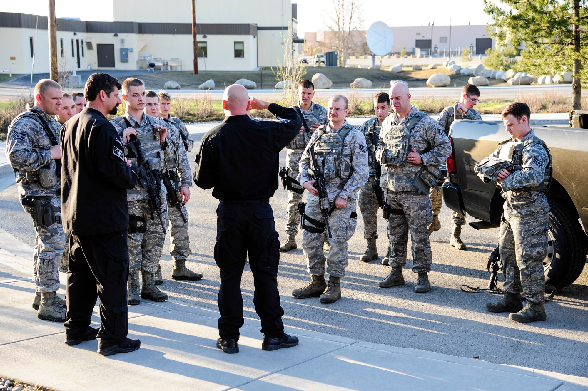 Trainers from Analytic Services Inc. brief defenders from the 354th Security Forces Squadron after a simulated hostile threat exercise May 8, 2014, Eielson Air Force Base, Alaska. The training was designed to help SFS Airmen respond to situations that may require immediate law enforcement action. (U.S. Air Force photo by Senior Airman Zachary Perras/Released)
