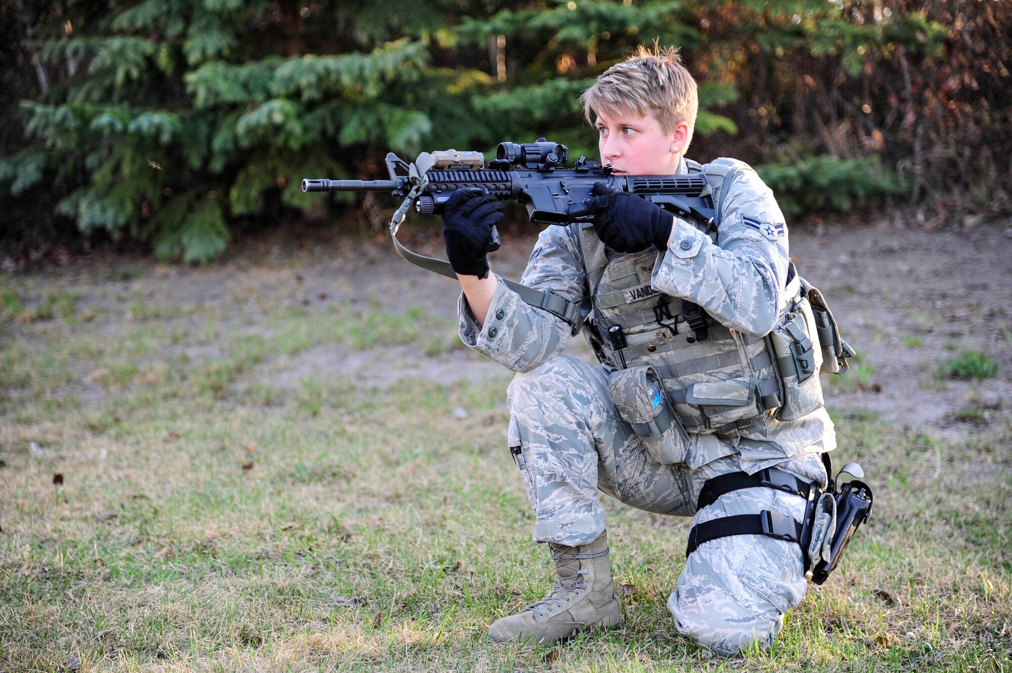 Airman 1st Class Kelly Vanderheiden, 354th Security Forces Squadron response force leader, keeps watch during a simulated active shooter scenario May 8, 2014, Eielson Air Force Base, Alaska. 354th SFS Airmen participated in high-risk response training which included various simulated threats to help improve response times. (U.S. Air Force photo by Senior Airman Zachary Perras/Released)