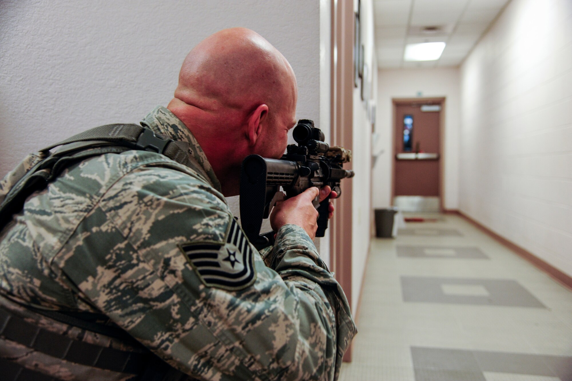 Tech. Sgt. Raymond Sorensen, 354th Security Force Squadron NCO in charge of standards and evaluations, aims his M-4 carbine down a hallway while engaging a simulated hostile target during high-risk response training May 8, 2014, Eielson Air Force Base, Alaska. Defenders from the 354th SFS participated in the training to help improve response effectiveness. (U.S. Air Force photo by Senior Airman Zachary Perras/Released)