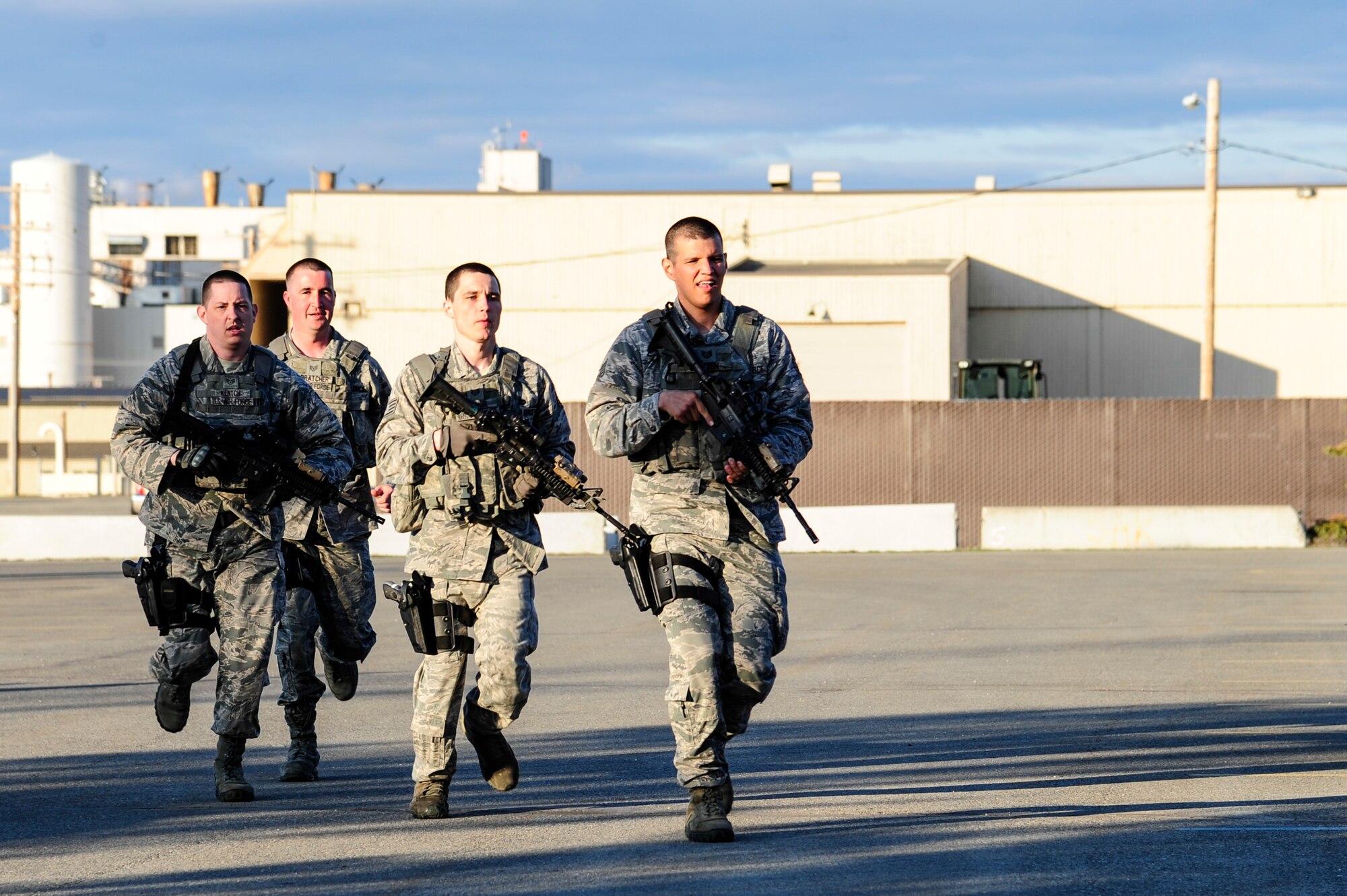 Defenders from the 354th Security Force Squadron prepare to engage a threat during high-risk response training May 8, 2014, Eielson Air Force Base, Alaska. The training is designed to help security forces Airmen prepare for unpredictable situations on military installations that may require immediate law enforcement action. (U.S. Air Force photo by Senior Airman Zachary Perras/Released)