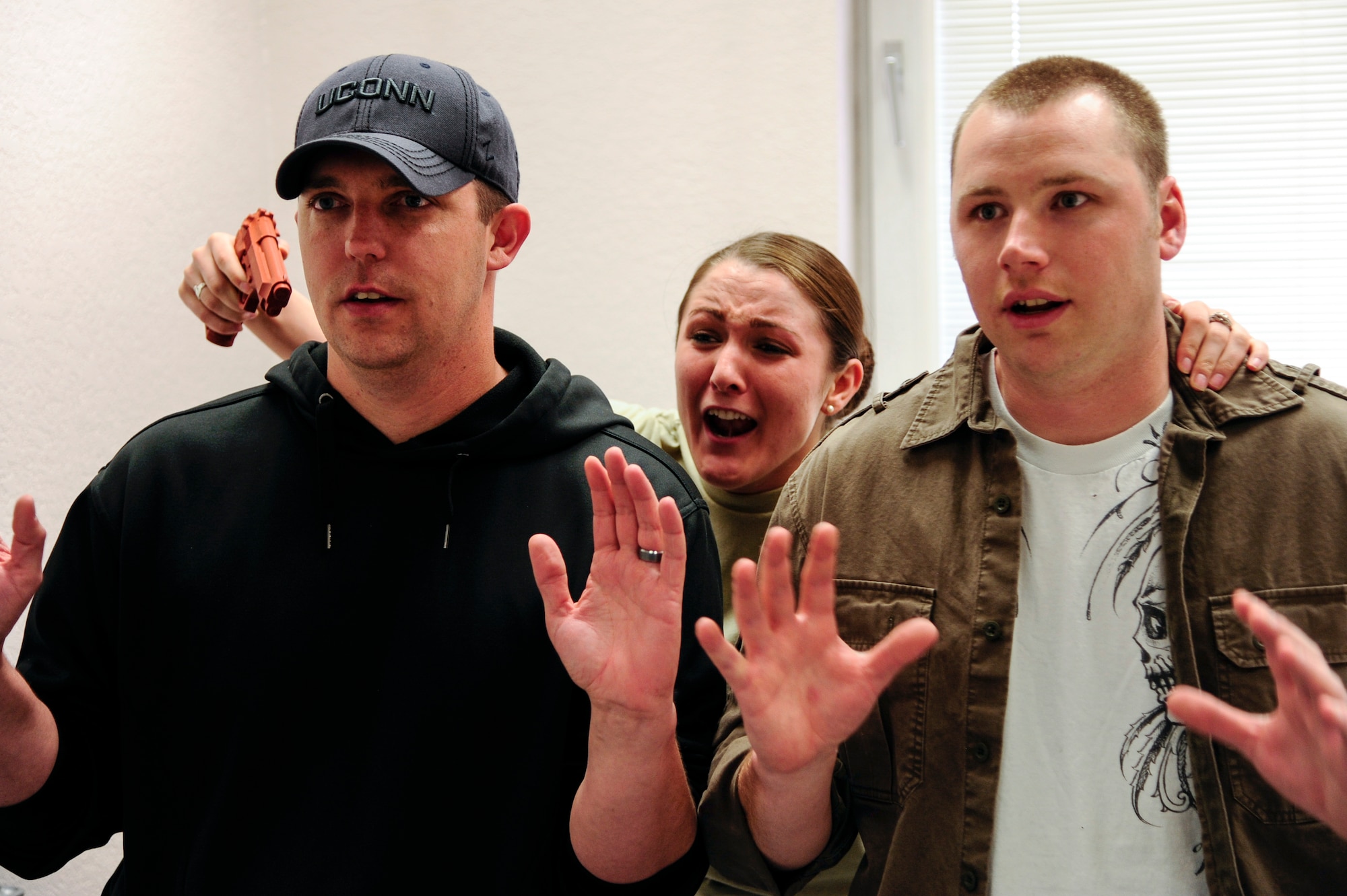 Airman 1st Class Alicia Lyons, 354th Force Support Squadron force management apprentice, holds hostages during a simulated active shooter scenario May 8, 2014, Eielson Air Force Base, Alaska. Defenders from the 354th Security Forces Squadron participated in Pacific Air Forces’ high-risk response training designed to help prepare them to meet dangerous situations. (U.S. Air Force photo by Senior Airman Zachary Perras/Released)