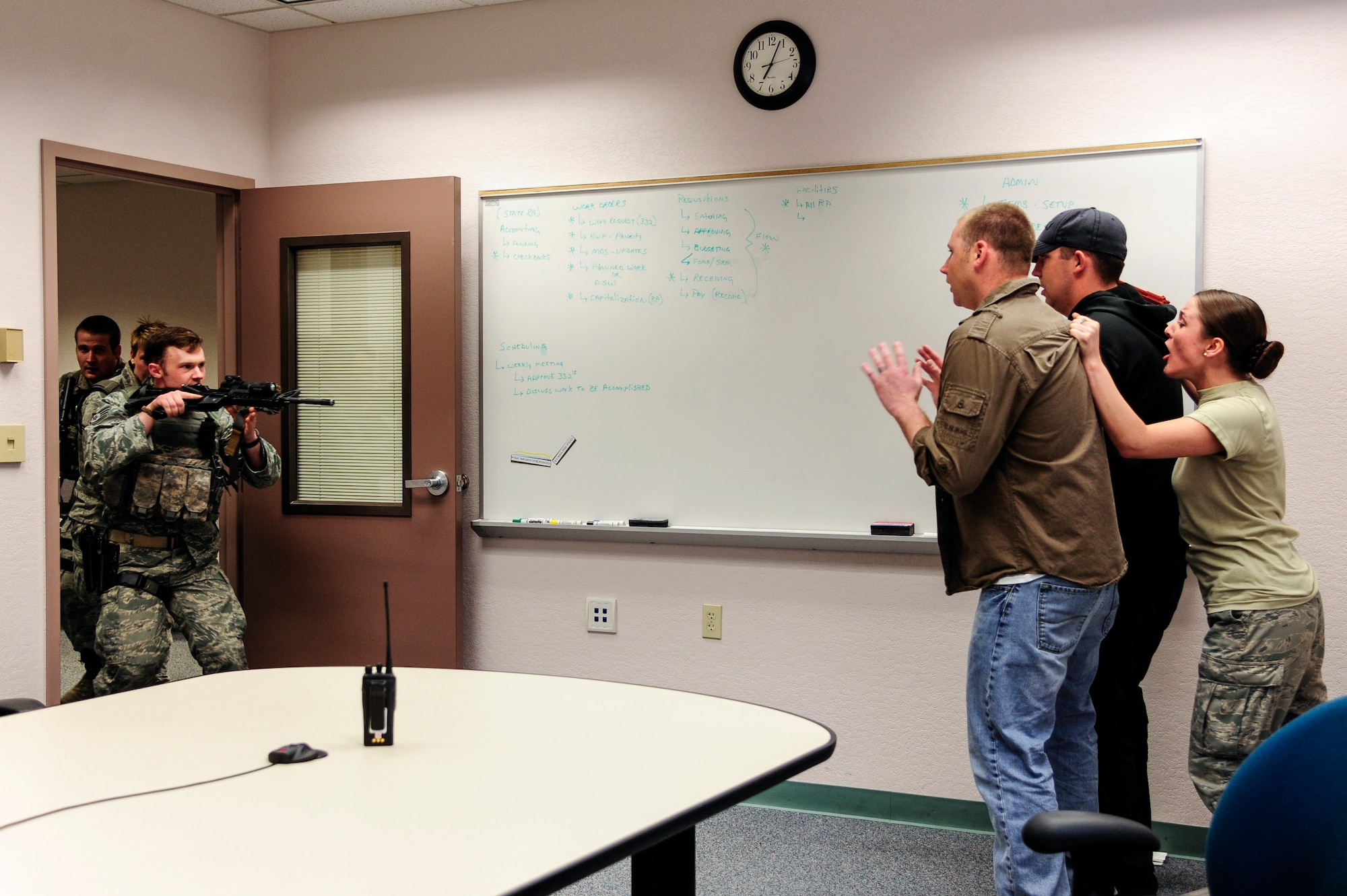 Defenders from the 354th Security Force Squadron engage with Airman 1st Class Alicia Lyons, 354th Force Support Squadron force management apprentice, during a simulated active shooter scenario May 8, 2014, Eielson Air Force Base, Alaska. The scenario was part of Pacific Air Forces’ high-risk response training. (U.S. Air Force photo by Senior Airman Zachary Perras/Released)