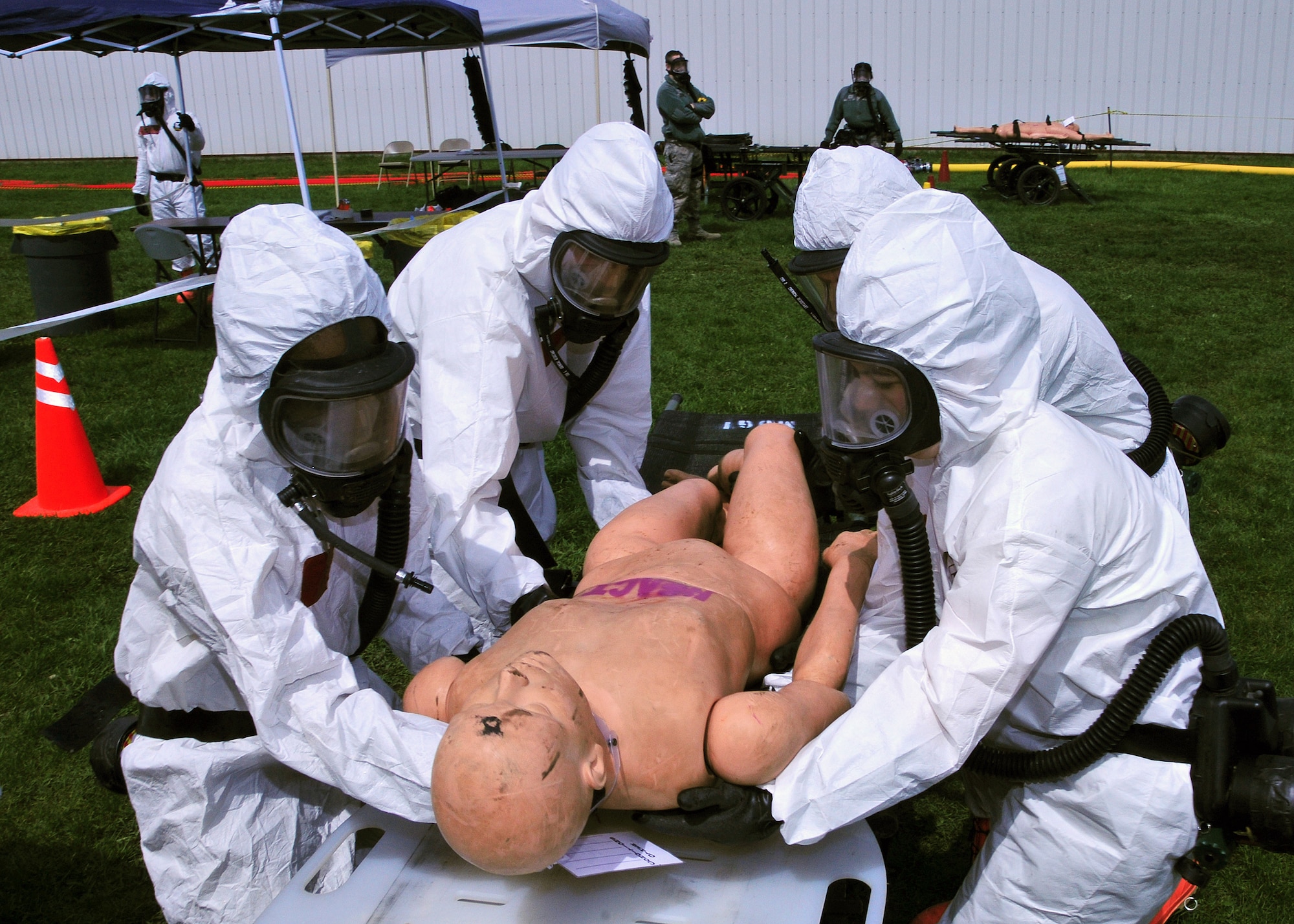 Wisconsin Army National Guard members perform mass decontamination of simulated casualties during an emergency preparedness exercise in Portage, Wisconsin, May 3, 2014. Columbia County Emergency Management, Divine Savior Hospital and the Wisconsin National Guard teamed up to practice the coordination and implementation of  their disaster response capabilities. (Air National Guard photo by Staff Sgt. Ryan Roth)