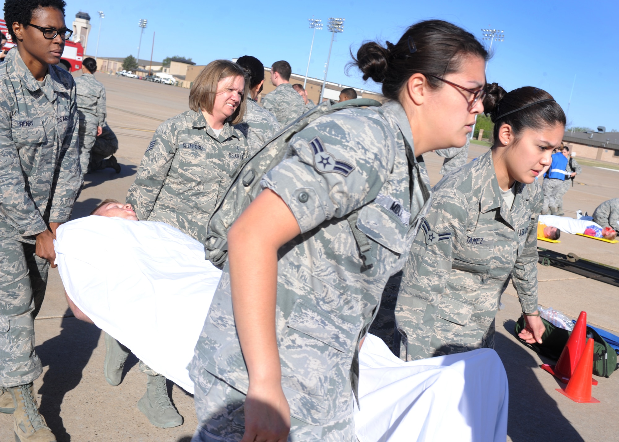 Volunteers move a simulated patient during an exercise May 6, 2014 at Cannon Air Force Base N.M. The exercise was designed to enhance Cannon’s preparedness and safety prior to the air show which is scheduled to take place May 24 and 25. (U.S. Air Force photo/Senior Airman Ericka Engblom)