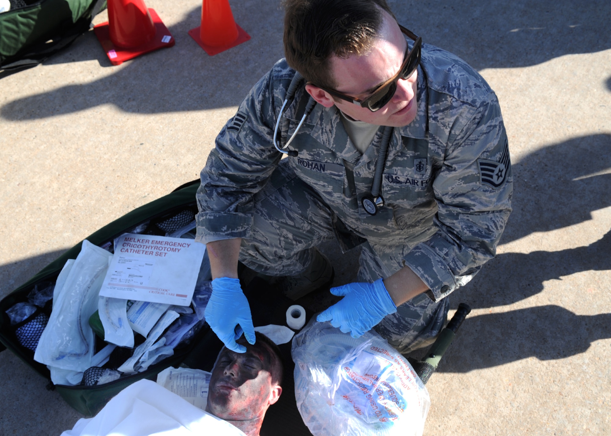 U.S. Air Force Staff Sgt. Michael Rohan, 27th Special Operations Aerospace Medicine Squadron independent duty medical technician, treats a man with simulated wounds during an exercise May 6, 2014 at Cannon Air Force Base N.M. The exercise was designed to enhance Cannon’s preparedness and safety prior to the air show which is scheduled to take place May 24 and 25. (U.S. Air Force photo/Senior Airman Ericka Engblom)