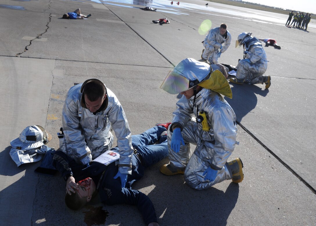 Members of the 27th Special Operations Civil Engineer Squadron provide emergency medical treatment to the simulated wounded during an exercise May 6, 2014 at Cannon Air Force Base N.M. The exercise was designed to enhance Cannon’s preparedness and safety prior to the air show which is scheduled to take place May 24 and 25. (U.S. Air Force photo/Senior Airman Ericka Engblom)