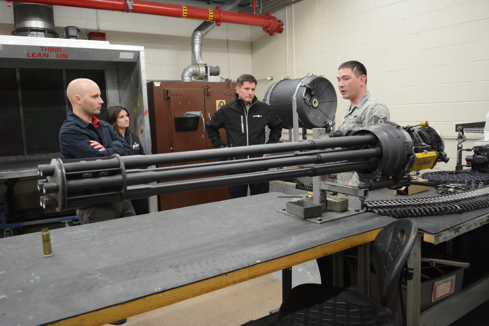 Tech. Sgt. Andrew D. Brickl, 115th gunshop supervisor, teaches the Leinenkugel family about the F-16 Fighting Falcon gun systems during a base visit to the 115 FW, Madison, Wis., May 3, 2014. The Leinenkugel family visited the base to share insight on how their military background helped them become a successful Wisconsin-based company. (Air National Guard photo by Senior Airman Andrea F. Liechti)