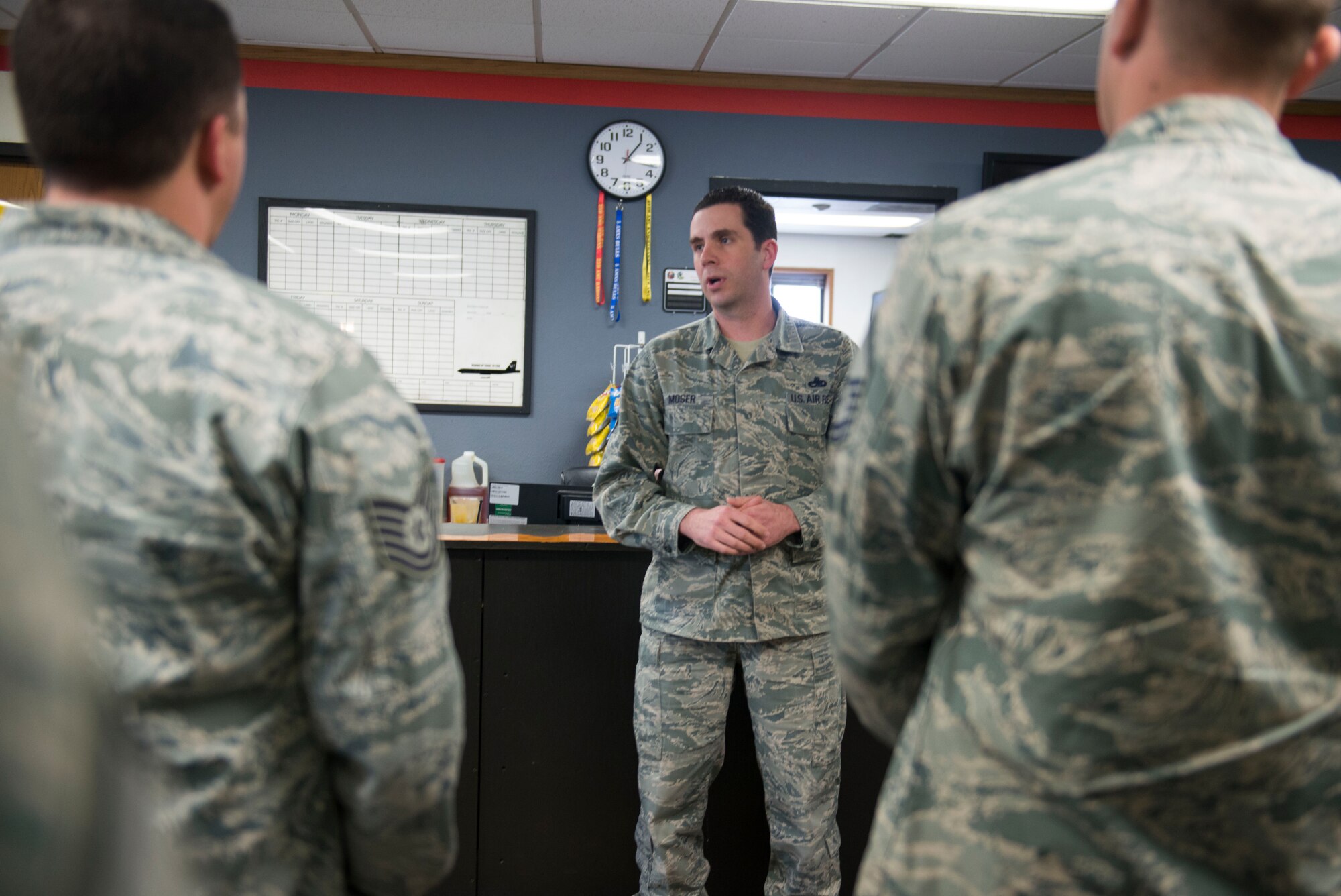 Senior Master Sgt. Michael B. Moser, the superintendent for the 23rd Aircraft Maintenance Unit, instructs his Airmen at Minot Air Force Base, N.D., May 7, 2014. Moser was recently awarded the Lieutenant General Leo Marquez award for superior service in maintenance. (U.S. Air Force photo/ Airman 1st Class Sahara L. Fales)