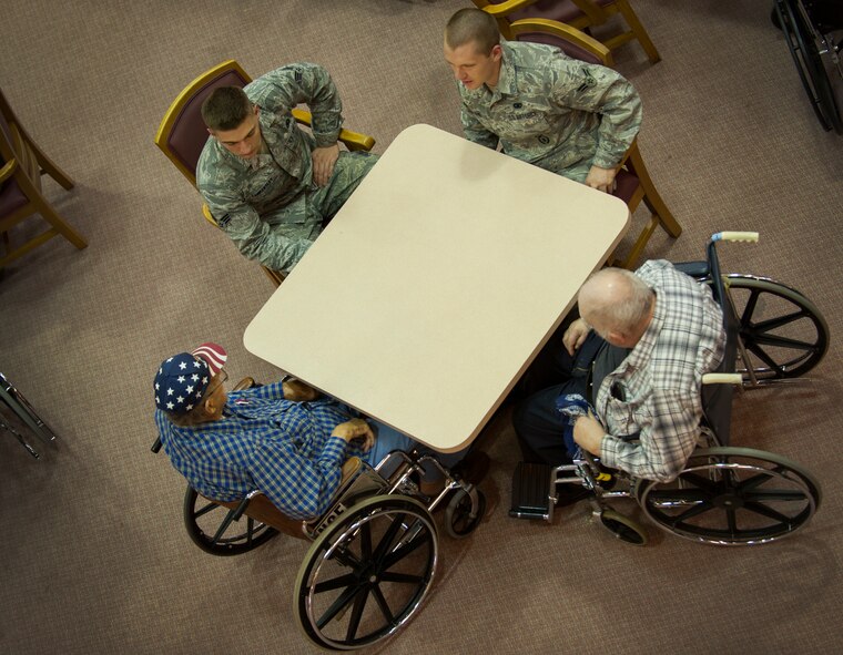 Airmen from the 791st Missile Security Forces Squadron volunteer group Friends of Veterans visit with veterans at Trinity Homes in Minot, N.D., May 3, 2014. The volunteer group bridges the gap between the military of yesterday and the military of today. (U.S. Air Force photo/Airman 1st Class Apryl Hall)