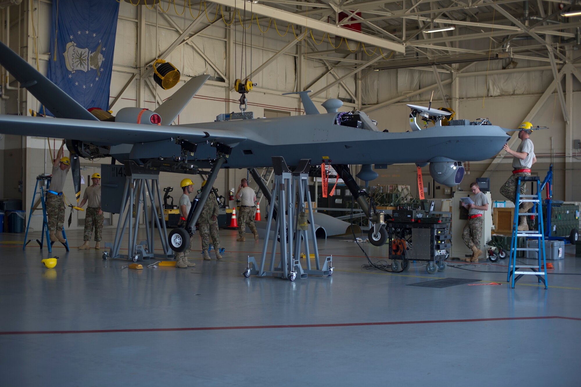Airmen from Cannon Air Force Base assemble an MQ-9 Reaper at Hurlburt Field, Fla., April 23, 2014; this was the first year the MQ-9 participated in Emerald Warrior. Emerald Warrior is a U.S. Special Operations Command-sponsored two-week joint/combined tactical exercise designed to provide realistic military training in an urban setting. (U.S. Air Force photo/Staff Sgt. John Bainter)