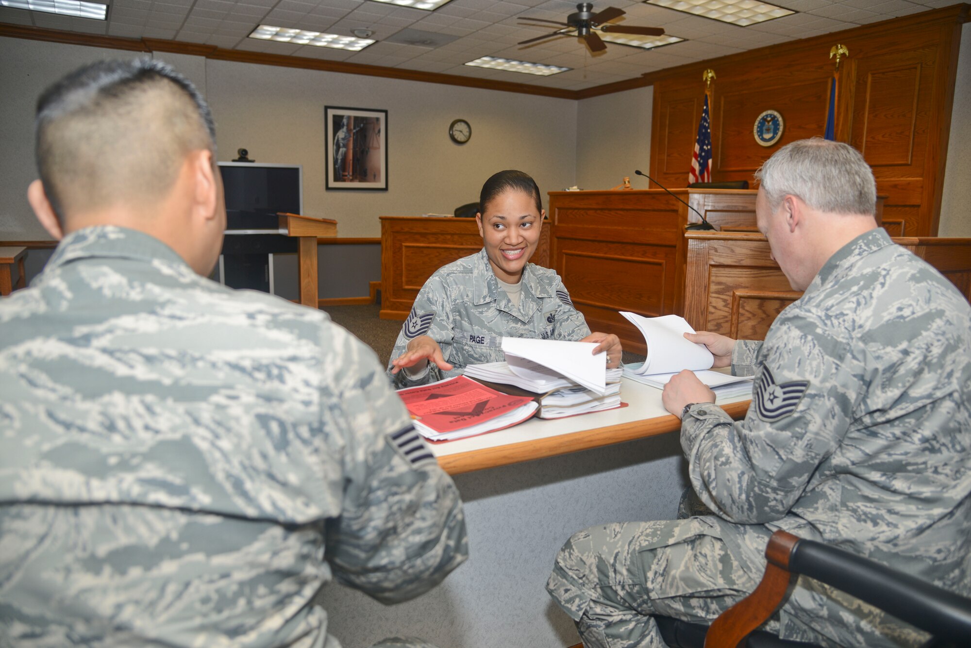 Tech. Sgt. Regina Page, 22nd Air Refueling Wing Judge Advocate general law NCO in charge, reviews records with her coworkers, May 5, 2014, at McConnell Air Force Base, Kan. Page was selected to be the 22nd ARW spotlight performer for the week of March 24 through 28. (U.S. Air Force photo/Airman 1st Class John Linzmeier)