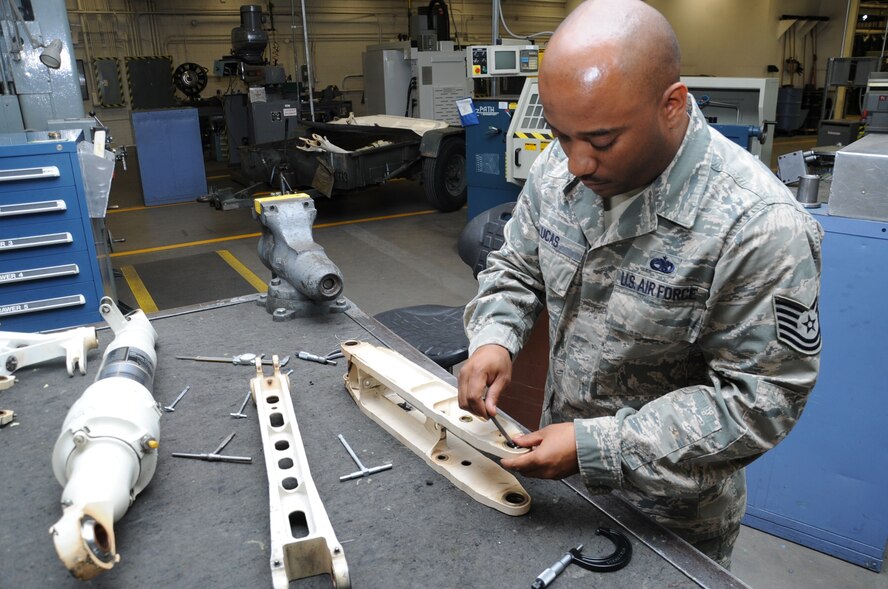 Tech. Sgt. Matthew Lucas, 56th Equipment Maintenance Squadron Fabrication Flight aircraft metals technology NCO in-charge, inspects landing gear components April 29 at Luke Air Force Base. Aircraft metals technology technicians inspect and service F-16 Fighting Falcon landing gear components every 72 months. (U.S. Air Force photo/Staff Sgt. Luther Mitchell Jr.)