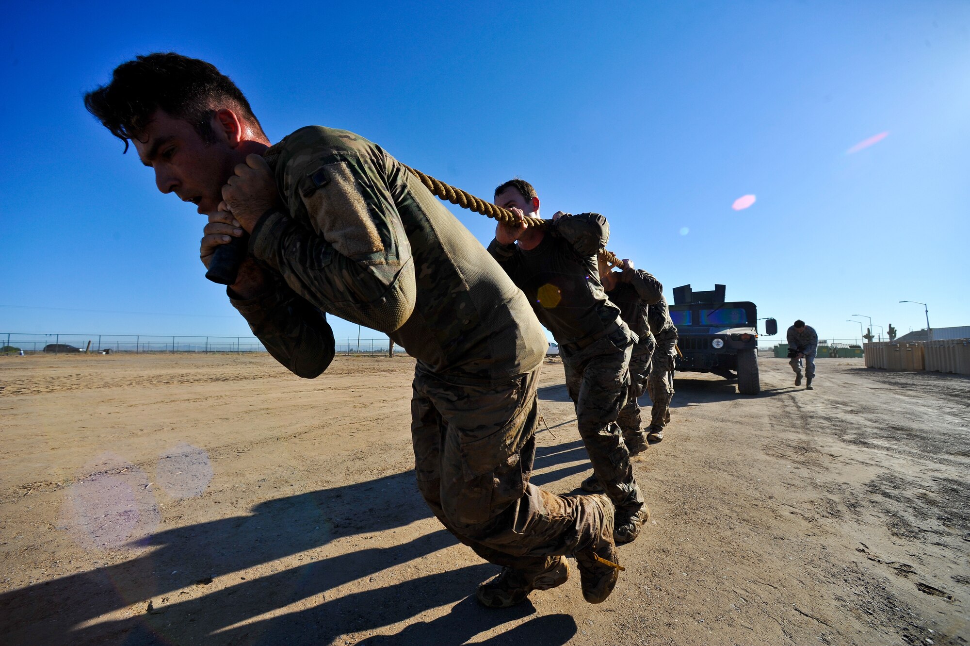 EOD Airmen pull a Humvee as part of the challenge. Participants also completed a 70-pound rucksack run, an under-fire obstacle and a downed team member litter carry. (U.S. Air Force photo/Senior Airman Jason Colbert)