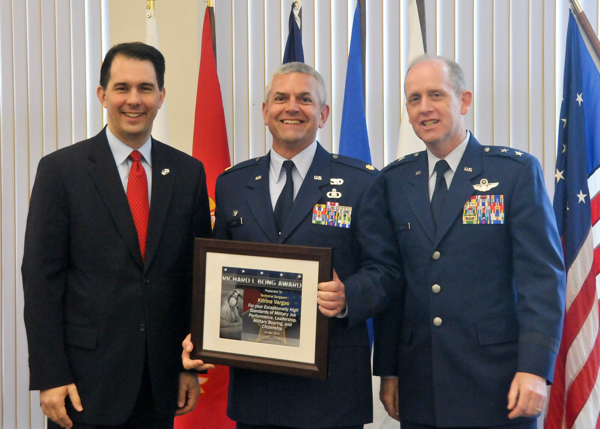 Maj. John Capra receives the Richard I. Bong Award on behalf of Technical Sgt. Kitrina Vargas for outstanding skill, dedication, and professionalism on and off duty.  The Employer Support of the Guard and Reserve sponsored the annual Breakfast with the Boss event here at the 128th Air Refueling Wing on May 12, 2014.  (U.S. Air National Guard photo by Airman Morgan Lipinski/Released).