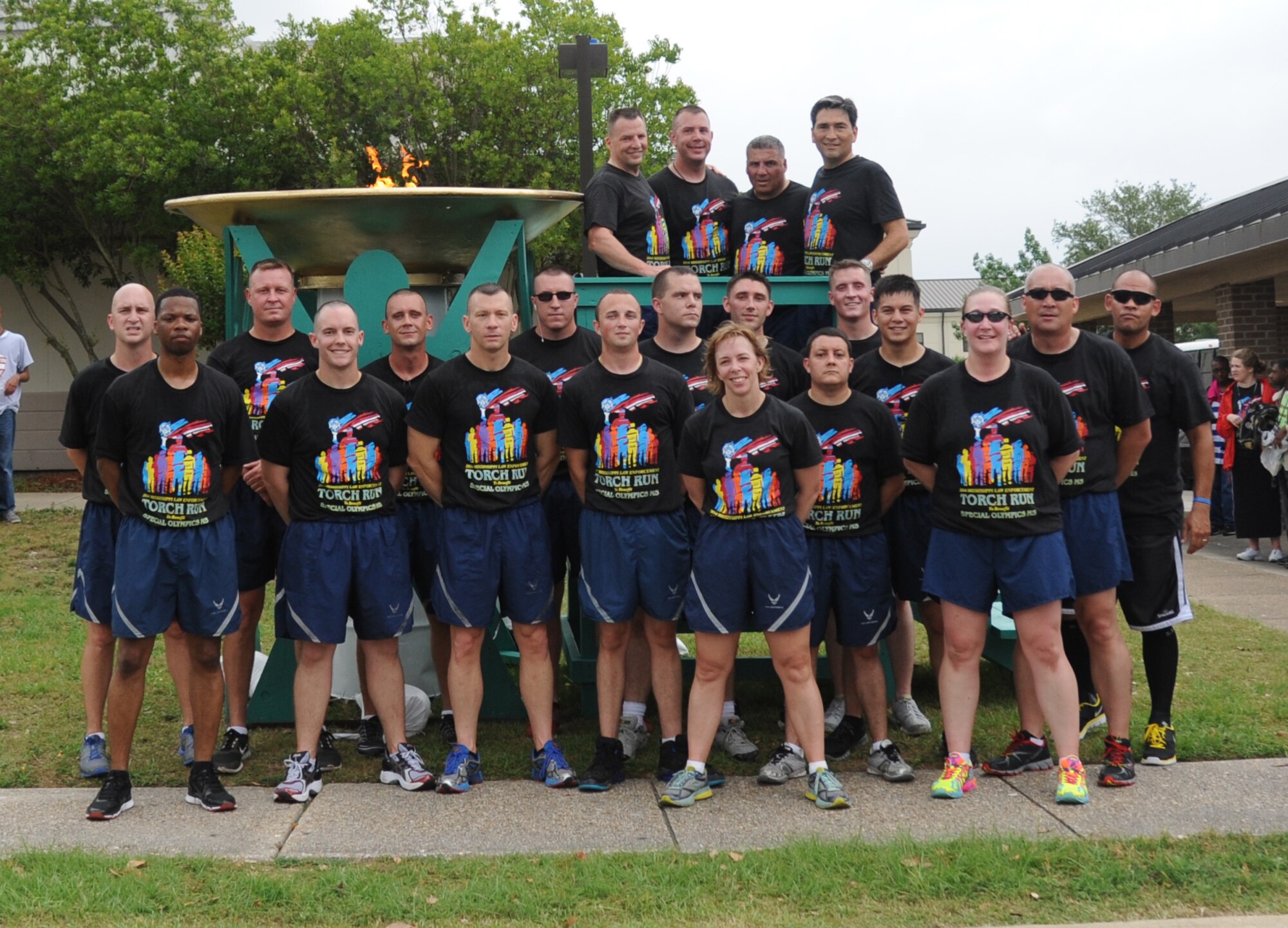 Brig. Gen. Patrick Higby, 81st Training Wing commander, and Col. René Romero, 81st TRW vice commander, stand with members of the 81st Security Forces Squadron following the Mississippi's Special Olympics Law Enforcement Torch Run . The torch was carried through 21 communities by more than 100 state law enforcement agencies. This is the 28th year Keesler has hosted the state Special Olympics. (U.S. Air Force photo by Kemberly Groue)