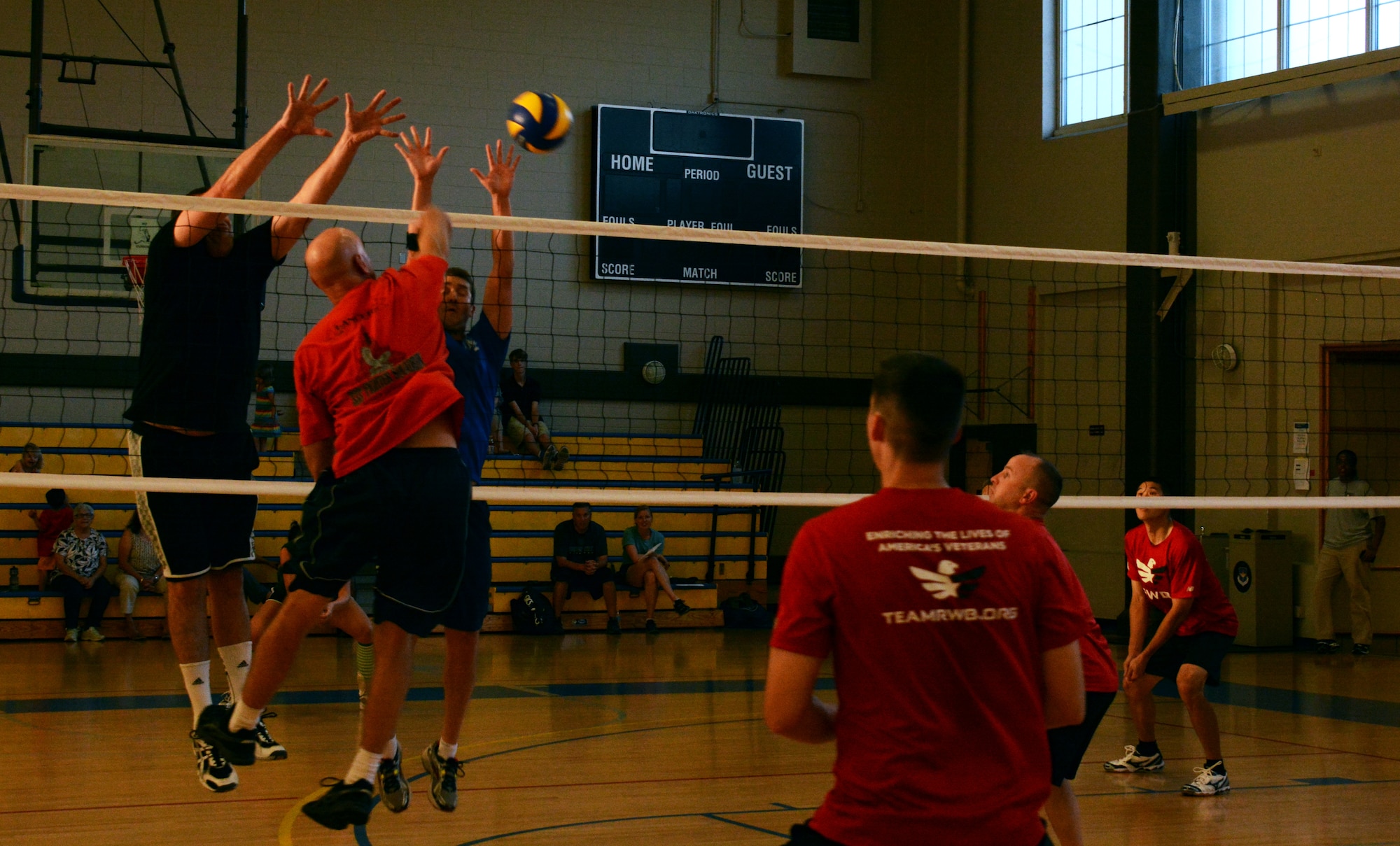 Col. Wayne Straw, Squadron Officer College jumps to put the ball over the net and past the opposing team’s defense during the 2014 Maxwell-Gunter Air Force Base intramural volleyball championship, May 6, 2014. The team SOC team (in red) lost to the Air Command and Staff College team, needing to win five matches against the ACSC teams need to win two. (U.S. Air Force Photo by Staff Sgt. Gregory Brook) 