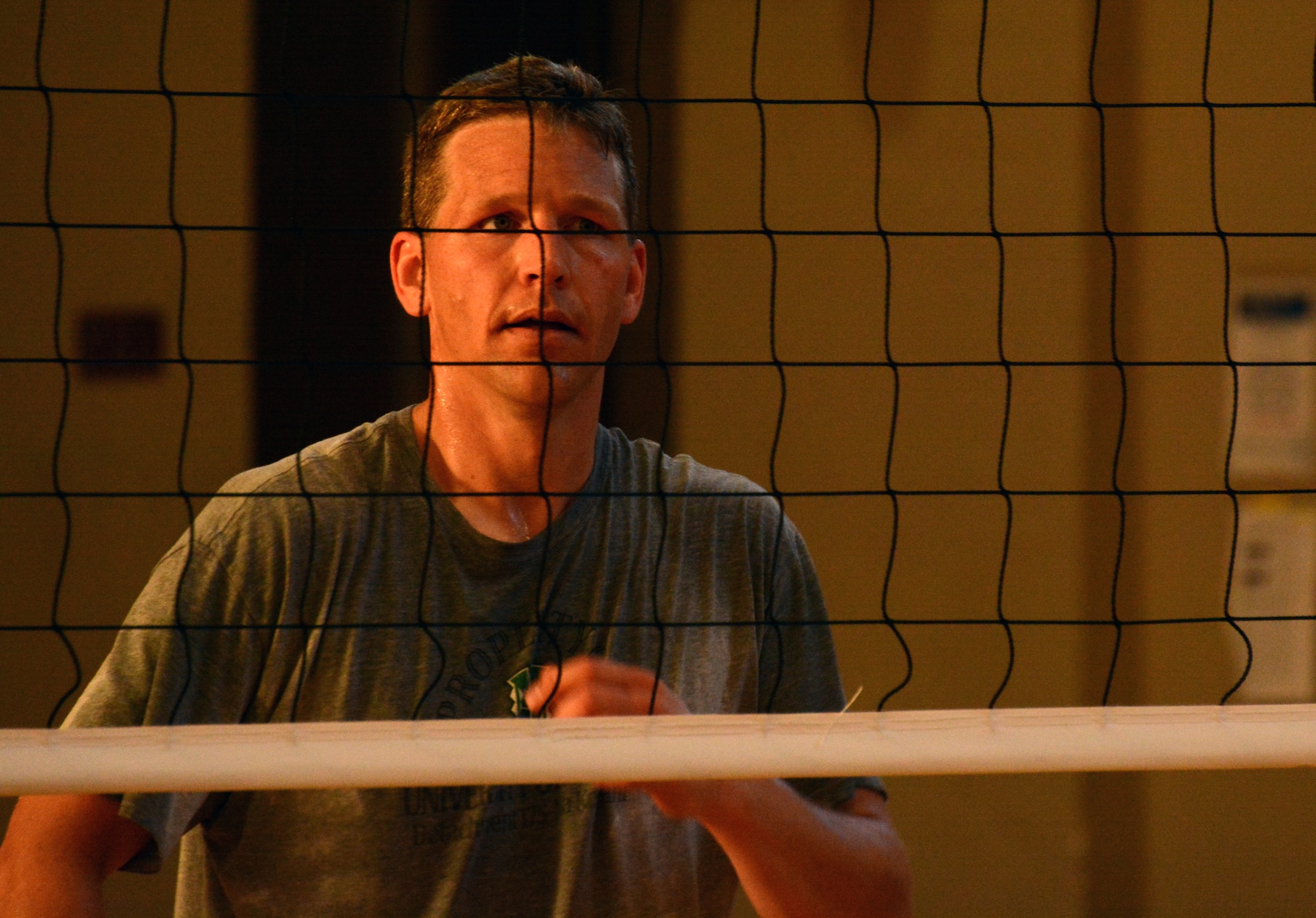 Maj John Wagemann, a student at Air Command and Staff College guards the net during a volley at the 2014 Maxwell-Gunter Air Force Base intramural Volleyball championship, May 6, 2014. The match was played between a team of ACSC students and a team from the Squadron Officer College here. (U.S. Air Force Photo by Staff Sgt. Gregory Brook)