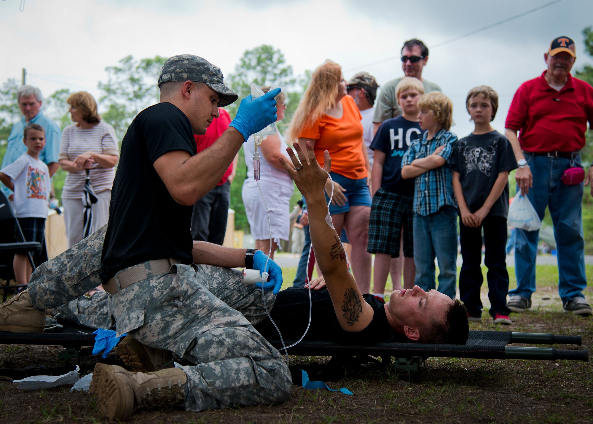 Spc. Kyle Kraft performs a combat medical demonstration during the 6th Ranger Training Battalion’s Open House event May 10 at Eglin Air Force Base, Fla.  The event was a chance for the public to learn how Rangers train and operate. The event displays showed equipment, weapons, a reptile zoo, face painting and weapon firing among others. The demonstrations showed off hand-to-hand combat, a parachute jump, snake show, and Rangers in action.  (U.S. Air Force photo/Tech. Sgt. Sam King)